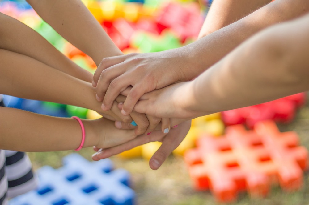 Young hands joined together